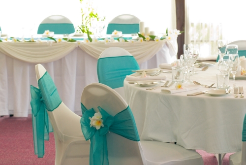 Beautiful tables with aqua chair ties and frangipani